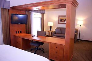 悉尼悉尼汉普顿酒店的配有书桌和电视的酒店客房