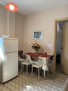米蒂利尼Modern House in Mytilene Center的用餐室配有桌椅和冰箱