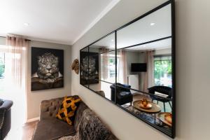 巴德茨维什安Juwel am Meer - Achat的带沙发和大镜子的客厅