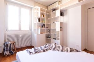 米兰Città Studi Terrace Suite with Jacuzzi - Top Collection的一间卧室设有一张床和一个书架