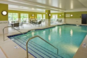 萨吉诺萨吉诺汉普顿套房酒店的酒店的大型游泳池配有桌椅