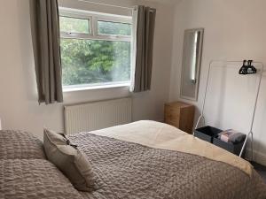 布莱克浦Richards Retreat Blackpool的卧室在窗户前配有一张床