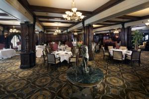 路易斯威尔路易斯维尔希巴希尔顿酒店的中间设有一间配有桌椅和雕像的餐厅