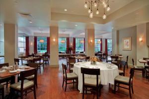 Pearl River珍珠河希尔顿酒店的一间带桌椅和吊灯的用餐室