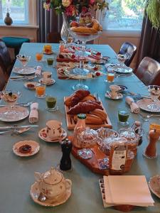 阿纳姆Bed and Breakfast Raapop的一张长桌子,上面有盘子和盘子