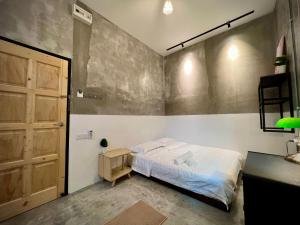 怡保DoSomething Guest House 5的一间卧室配有一张床和一扇木门