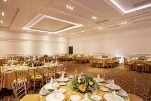 托卢卡Doubletree By Hilton Toluca的一个带桌椅的大型宴会厅