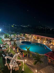 林贝Marcsons Hotels and Resorts的一个带桌椅的大型游泳池