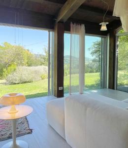 福松布罗内Agriturismo "Le Cannelle" spa & day wellness的卧室配有白色沙发和大窗户