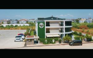 安塔利亚LARA MARİNE HOMES的停车场内有车辆的建筑物