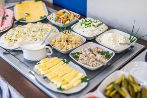 弗罗茨瓦夫皮亚斯特弗罗茨瓦夫中枢酒店的餐桌上的自助餐,包括不同种类的食物