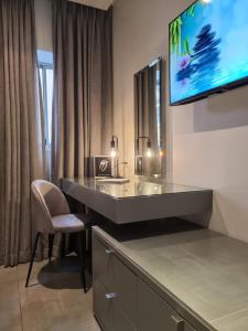 开普敦大西洋事理精品酒店的一间带书桌的浴室和墙上的电视