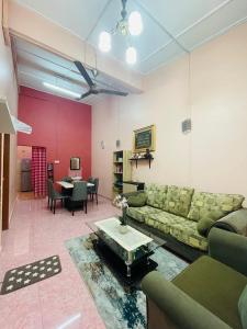 哥打巴鲁Kota Bharu Homestay的客厅配有沙发和桌子