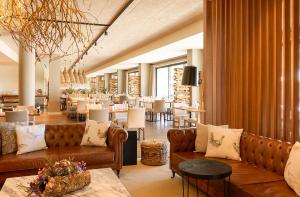 埃武拉Octant Evora的一个带沙发和桌子的大堂以及一间餐厅