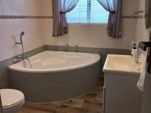 乔治Breathe Inn的带浴缸、卫生间和盥洗盆的浴室