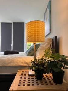 埃因霍温Room 101 - Eindhoven的一间卧室配有一张床和一张带台灯的桌子