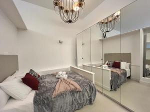 马德里Exclusivo Piso Madrid Mendizabal的一间卧室配有两张床和镜子