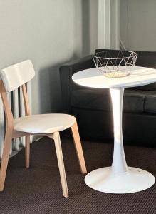 马尔杜HOSTEL/HOTELL 3A的一张白色桌子和一张沙发旁的椅子