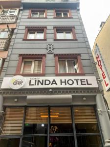 伊斯坦布尔Kadıköy Linda Hotel的前面有酒店标志的建筑