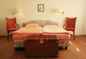 科尔平塞Villa Daheim - FeWo 02的一间卧室配有一张床和两把椅子