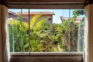 戈亚斯州上帕莱索Vita Chalés, na avenida central的开放式窗户,享有花园的景色