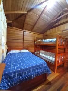 巴尼奥斯Paraiso Orquideario的小屋内设有一间带两张双层床的卧室