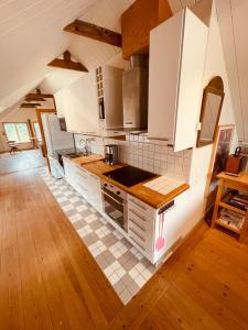 VeberödSkogslund, Skåne的厨房配有白色橱柜和瓷砖地板。