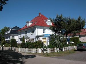 奥茨塞巴德·迪尔哈根Haus Sonneneck 2的一座大型白色房屋,设有红色屋顶