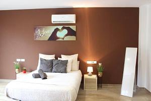 莫尼斯特罗尔Barceló Apartaments的一间卧室设有一张大床和棕色的墙壁