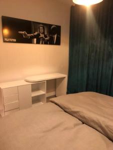 明斯特Eine 2 Zimmer Ferienwohnung Münster City的一间卧室配有一张床、一张桌子和一张图片