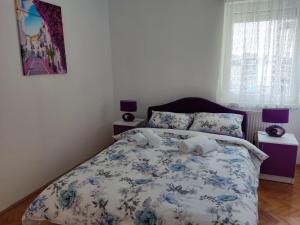 比耶利纳Apartman Novaković的一间卧室配有一张带蓝色和白色棉被的床