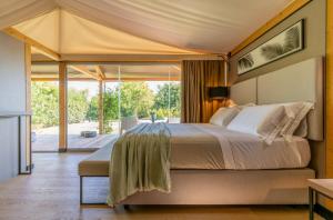 斯培基奥拉Infinito Resort的帐篷内一间卧室,配有一张大床