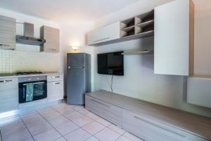 安泰伊-萨伊恩特-安德尔埃Residence Covalou的厨房配有不锈钢冰箱和电视。