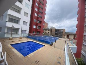 马尼萨莱斯apartamento ubicado parte histórica de manizales的一座建筑物中央的游泳池
