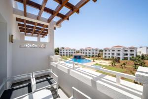 萨伊迪耶Radisson Blu Residences, Saidia的享有游泳池和建筑景致的阳台