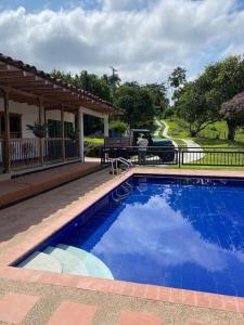 菲兰迪亚Alojamiento Rural - La Perla的一座大蓝色游泳池,位于房子前