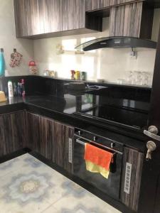 巴都安帕4BR Private Villa with Pool in the Heart of city的厨房配有带橙色毛巾的炉灶烤箱