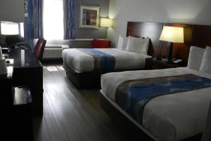 奥尔巴尼奥尔巴尼机场旅程住宿旅馆和套房酒店的酒店客房配有两张床和一张书桌