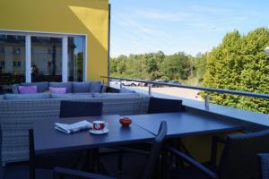 佛里茨斯坦德客栈餐厅酒店的带沙发的阳台配有蓝色的桌椅