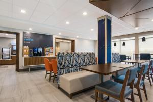 斯普林代尔Holiday Inn Express & Suites - Springdale - Fayetteville Area的一间带桌椅和柜台的用餐室