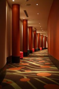 那霸那霸塔度假Spa酒店的大楼里带有红色柱子的走廊