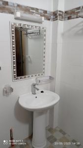 圣路易斯Chez Mamanta Studio meublé à St louis的浴室设有白色水槽和镜子