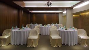 孟买The Mirador Andheri East的一间会议室,配有白色的桌椅