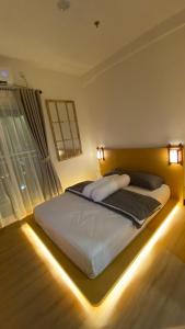 名古屋Japanese Zen Room Citra Plaza Nagoya Batam的一间卧室配有一张灯光床