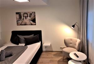 科特布斯Hotel Zum Postkutscher的一间小卧室,配有一张床和一把椅子