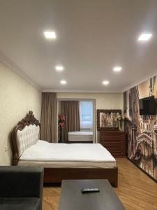 杰尔穆克HASI hotel Jermuk的一间卧室配有一张大床和一张沙发