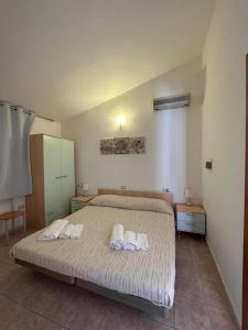 卡尔德杜La Corte Degli Ulivi的一间卧室配有一张床,上面有两条毛巾
