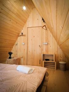 拉多夫吉卡PUŽMAN Farm Glamping的木制客房内的一间卧室,配有一张床