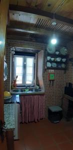 阿加尼尔Casa do Loureiro的厨房设有水槽和窗户。