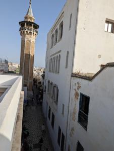 突尼斯Dar Hamouda Guest House - Médina de Tunis的一座建筑旁边设有钟楼